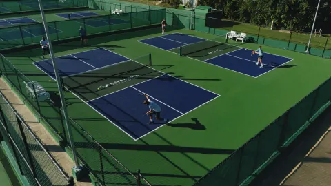 Aerial view of multiple outdoor tennis courts at Melia Caribe Beach Resort.