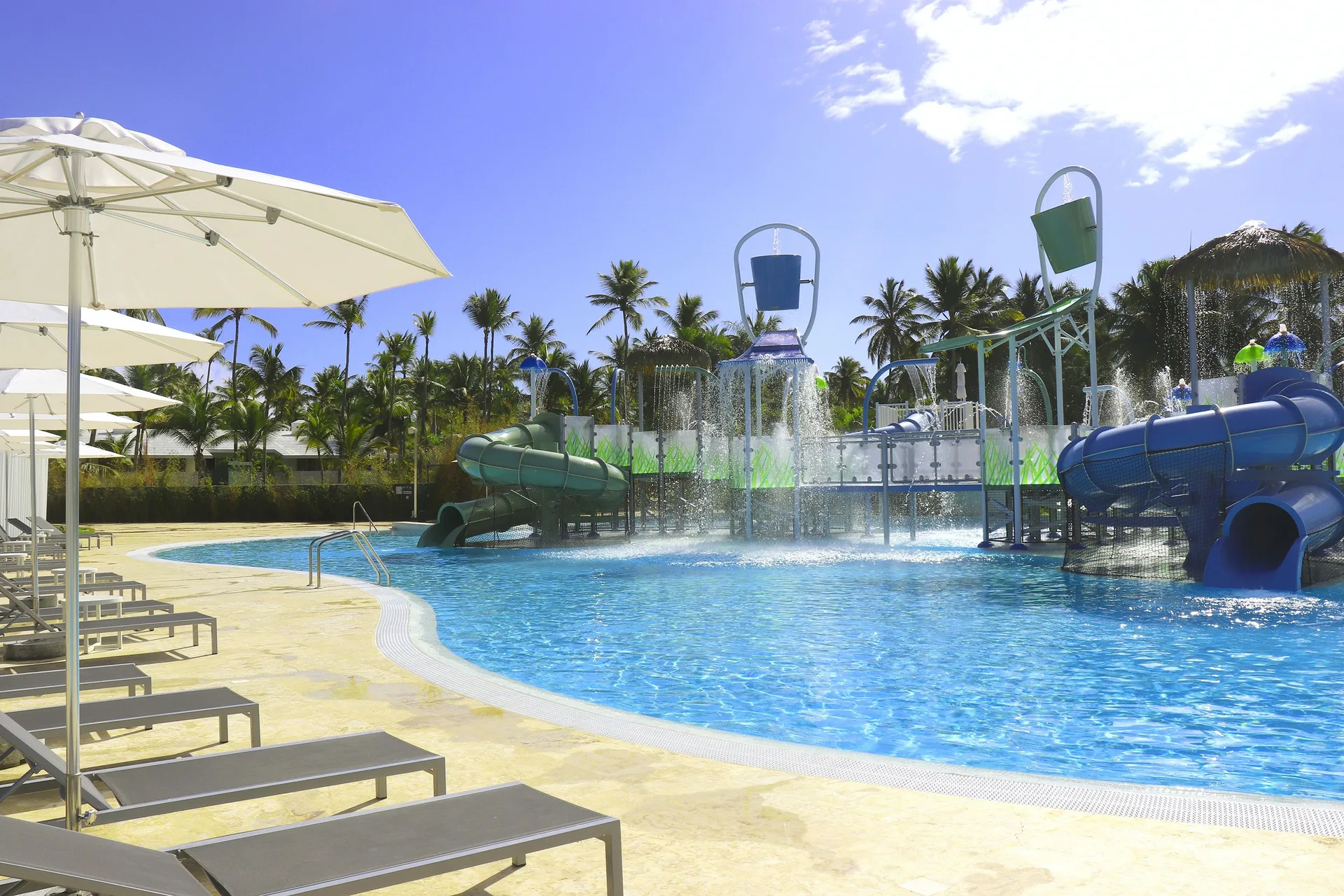 Water play pool with slides and loungers at Melia Caribe Beach Resort.