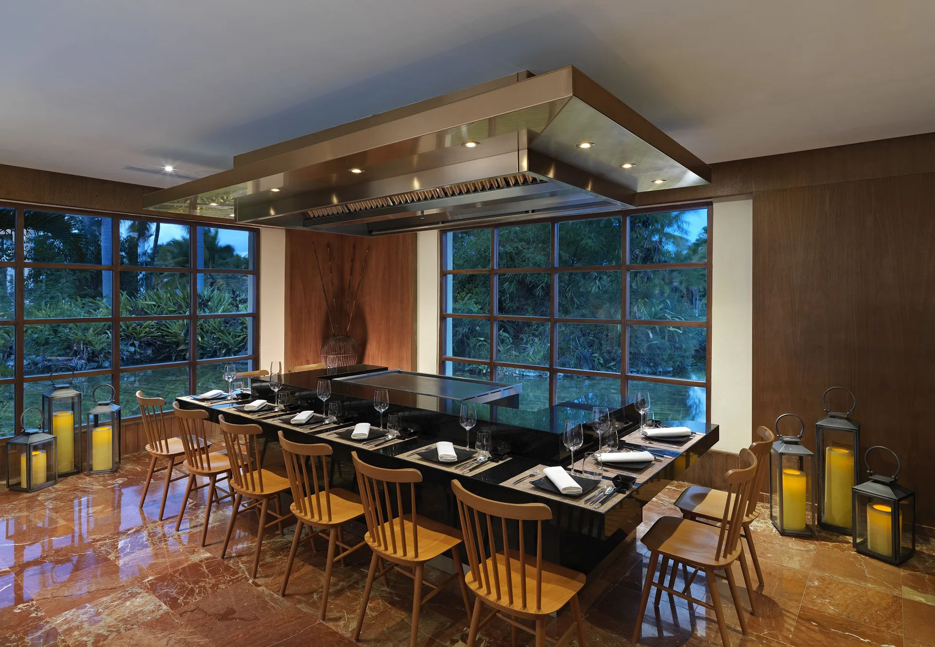 Teppanyaki grill counter with seating and large windows at Melia Caribe Beach Resort.