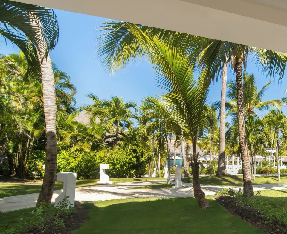 Deluxe Room garden view at Melia Caribe Beach Resort with palms and walkways outside.
