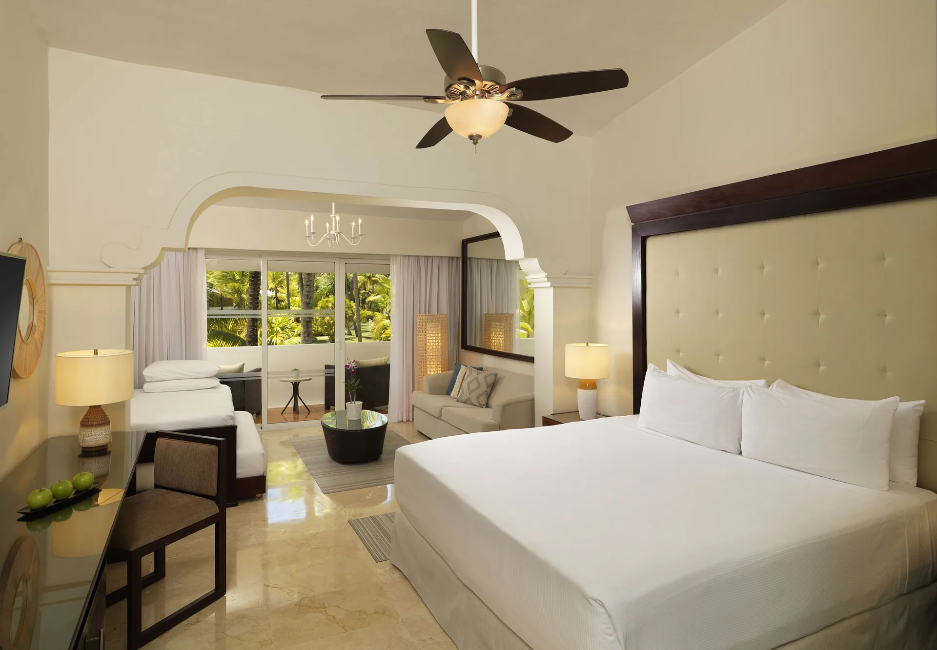 Family Room Tropical Palms with king bed and lounge area at Melia Caribe Beach Resort.