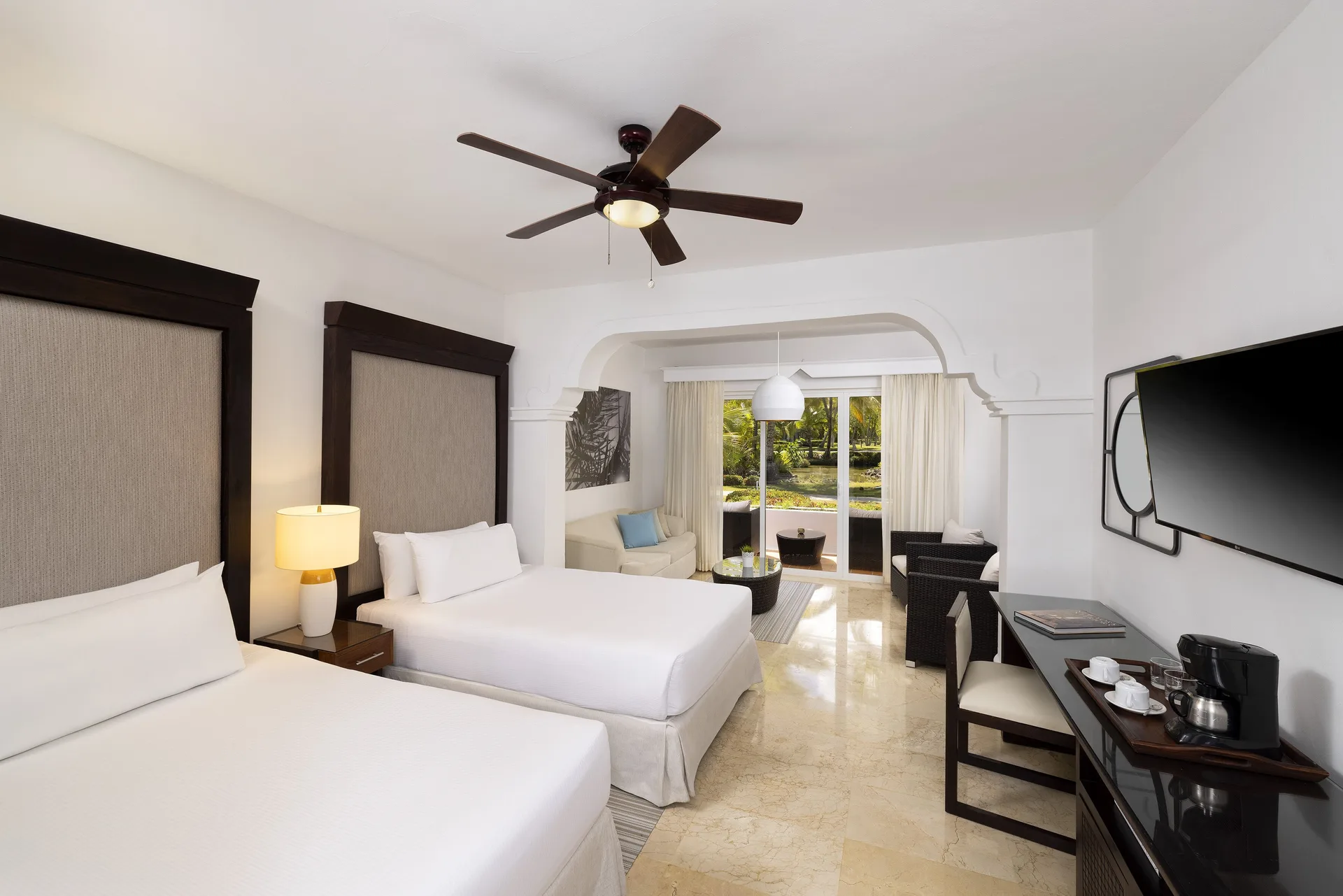 Two-bedroom suite with two beds and sitting area at Melia Caribe Beach Resort.