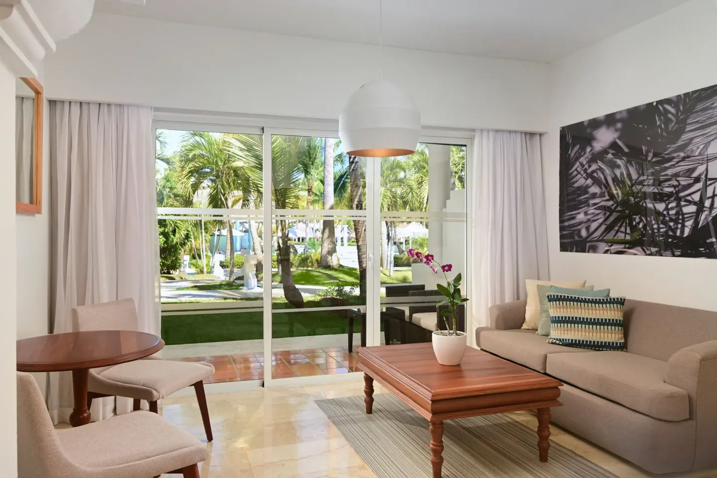 Sofa lounge and terrace doors in The Level Junior Suite Garden View at Melia Caribe Beach Resort.
