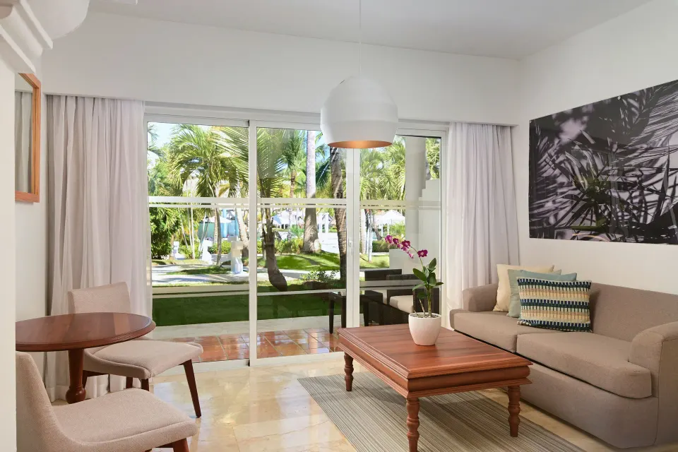 Sofa lounge and terrace doors in The Level Junior Suite Garden View at Melia Caribe Beach Resort.