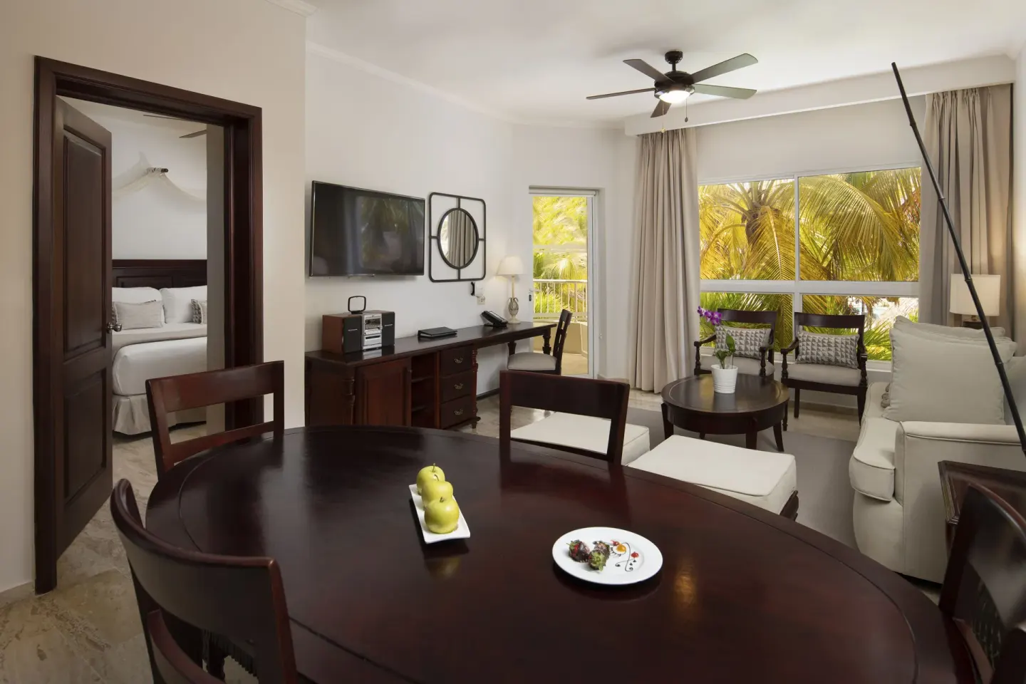 The Level Suite living and dining area with bedroom doorway at Melia Caribe Beach Resort.