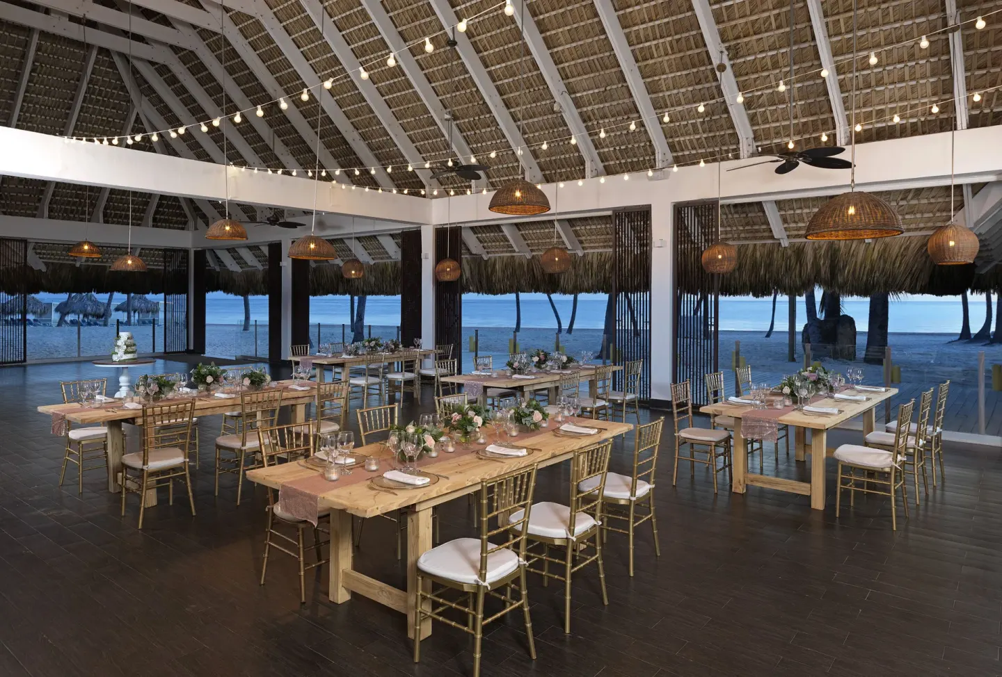 Beachfront event dining setup under a thatched pavilion at Melia Caribe Beach Resort.