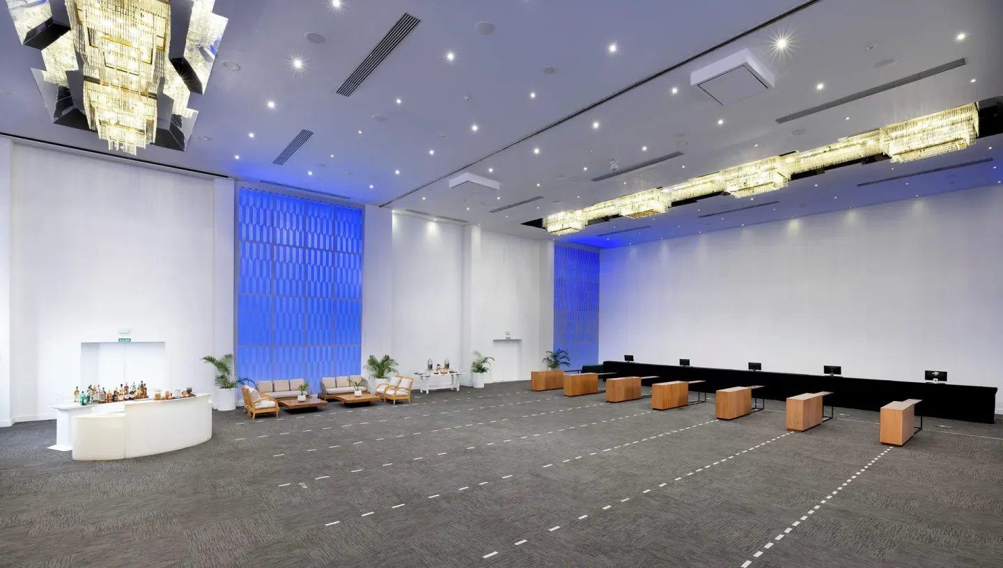 Large event hall with chandeliers and bar setup at Melia Caribe Beach Resort.
