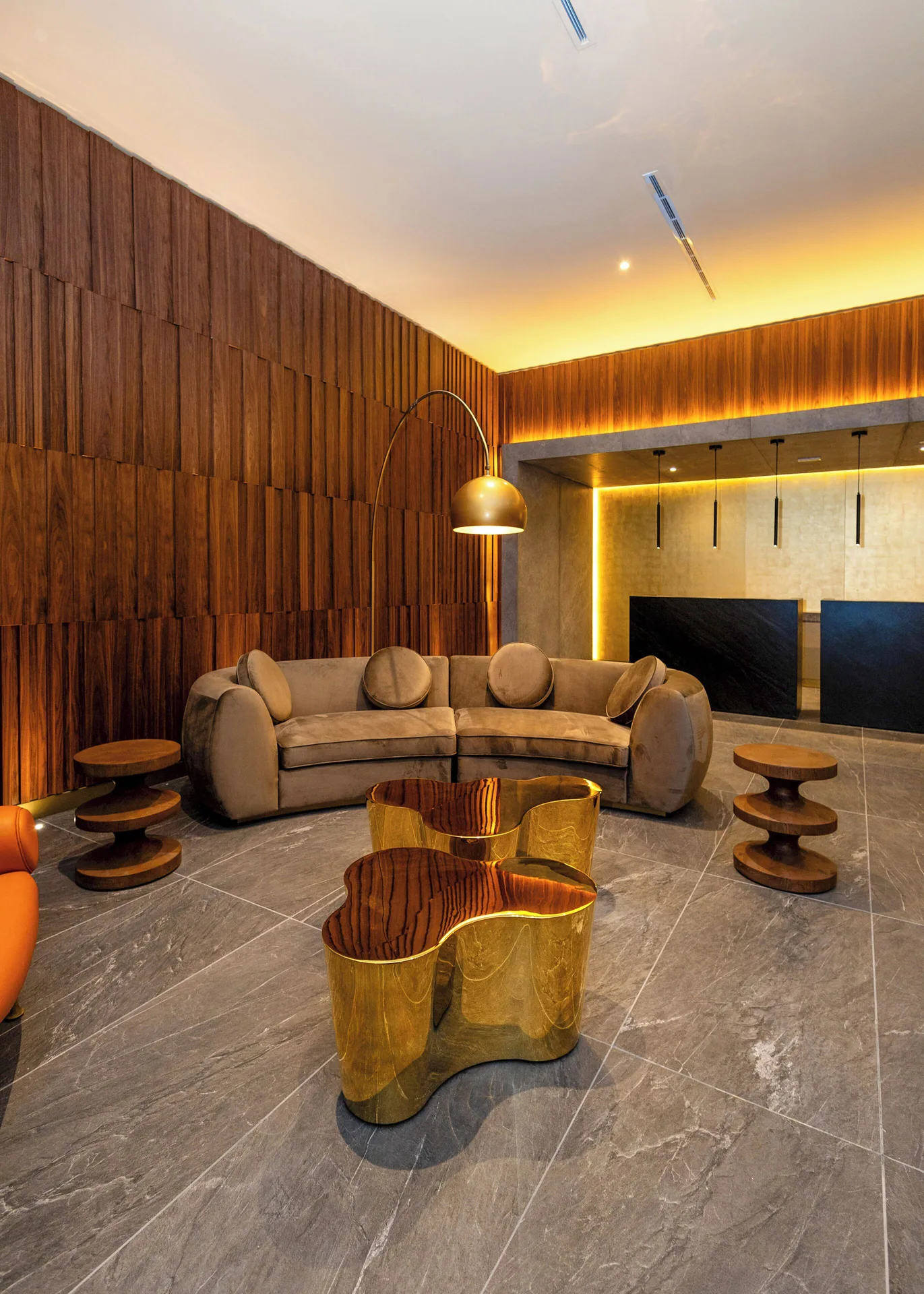 Curved sofa and gold tables in the lobby at Melia Casa Maya Cancun.