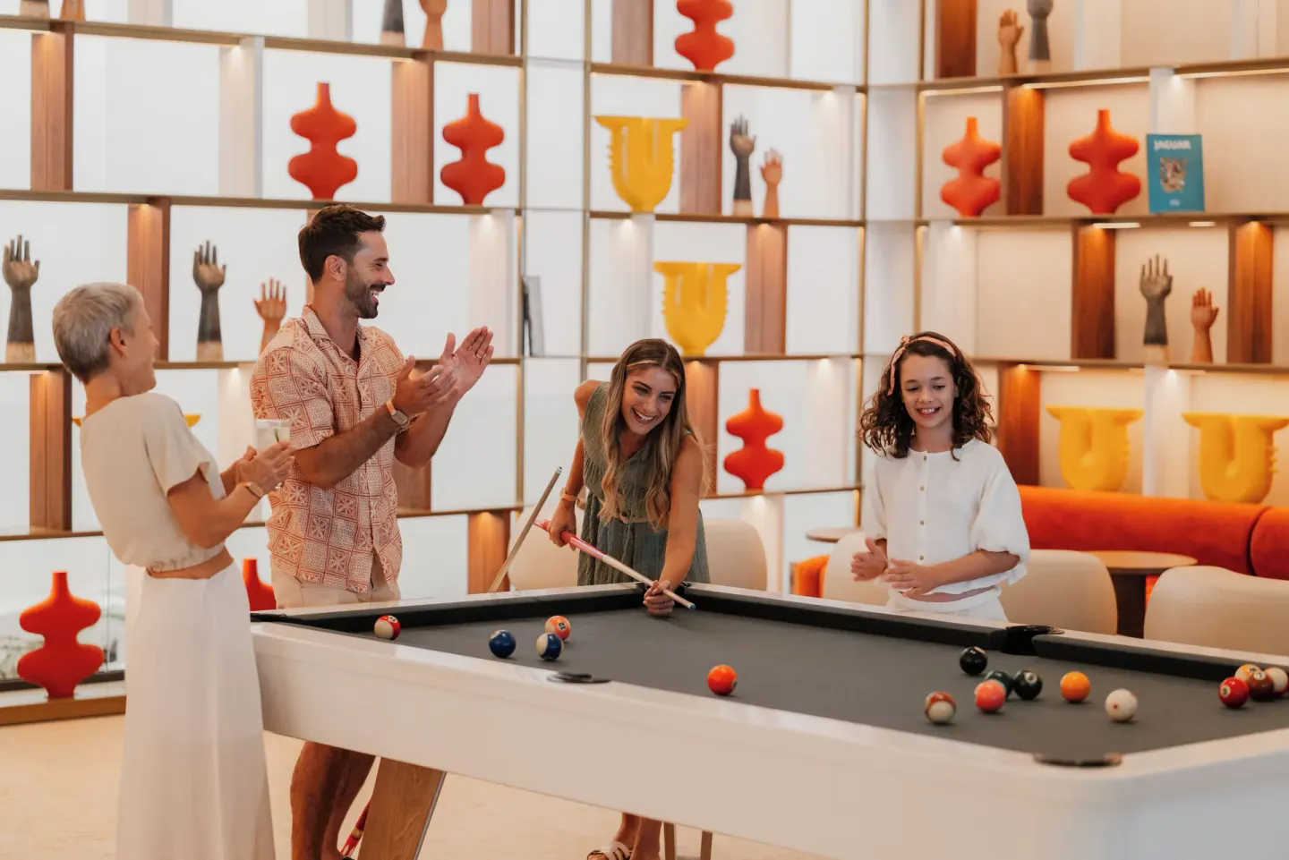 Family playing pool in a colorful lounge at Melia Casa Maya Cancun.
