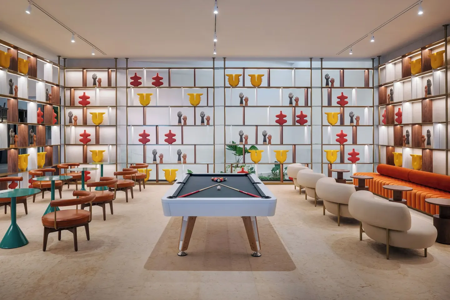 Lounge with pool table, seating, and colorful shelves at Melia Casa Maya Cancun.
