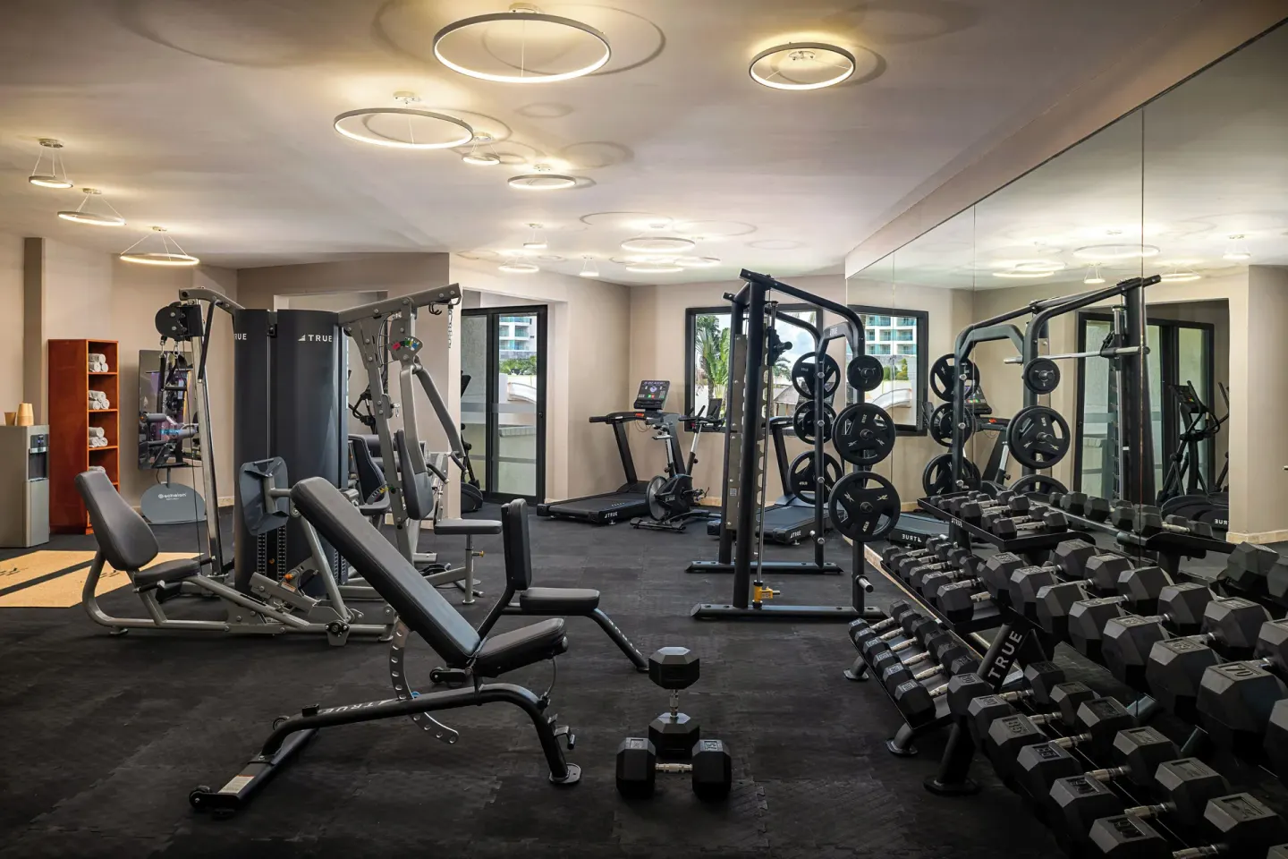 Gym with treadmills, benches, cable machines, mirrors, and dumbbell racks at Melia Casa Maya Cancun.