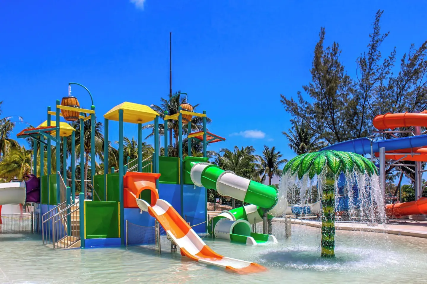 Kids water play structure with small slides and a palm spray feature at Melia Casa Maya Cancun.