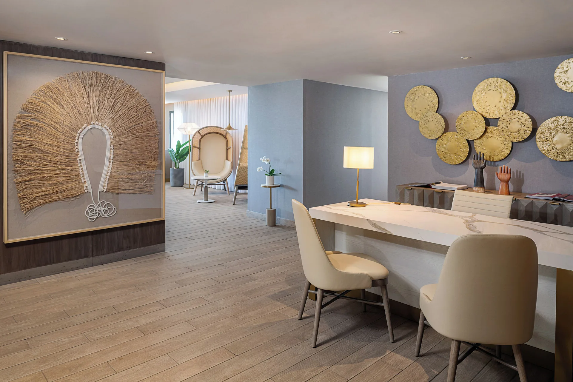 A reception desk with decorative wall art at Melia Casa Maya Cancun.