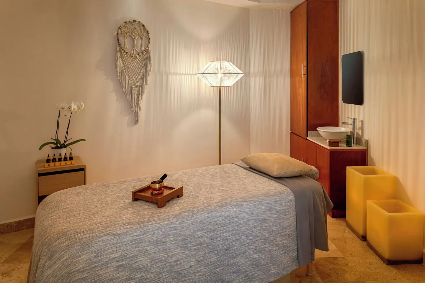 Single spa treatment room with massage bed and sink at Melia Casa Maya Cancun.