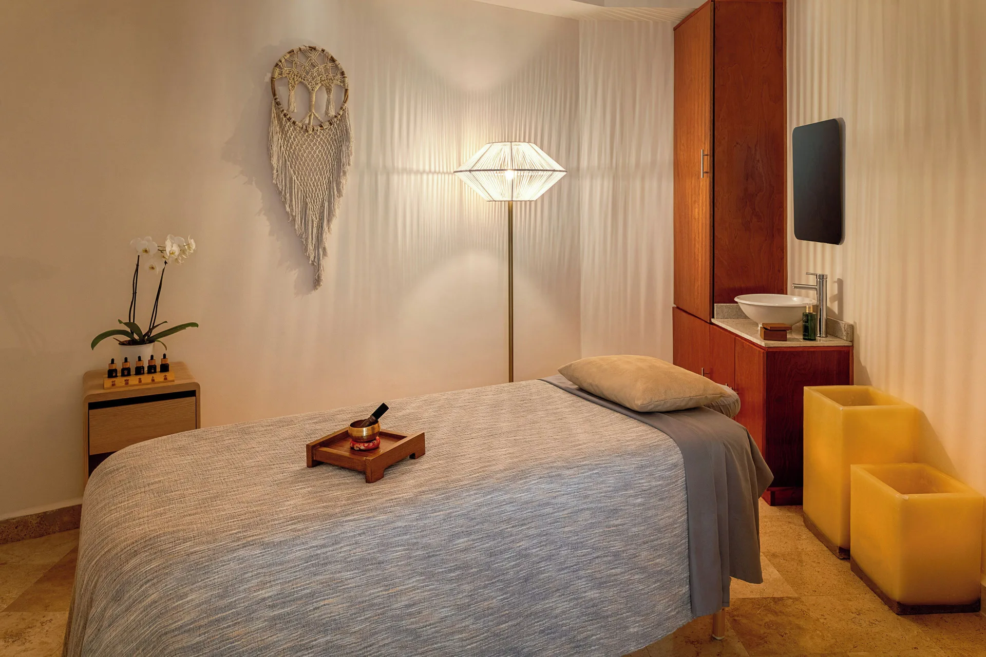 Single spa treatment room with massage bed and sink at Melia Casa Maya Cancun.