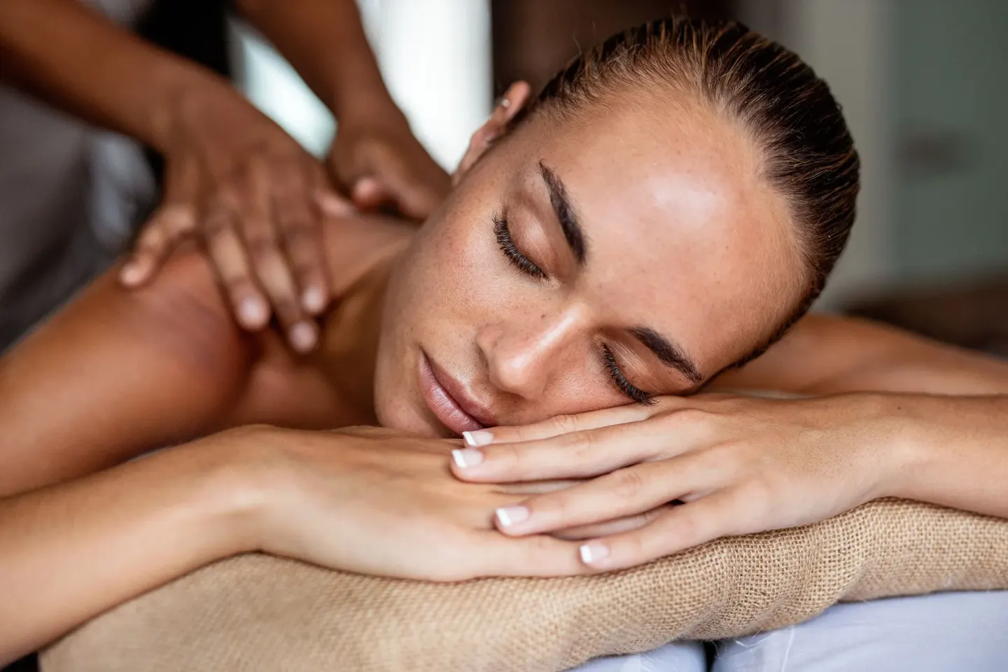 Guest receiving a shoulder massage on a spa table at Melia Casa Maya Cancun.
