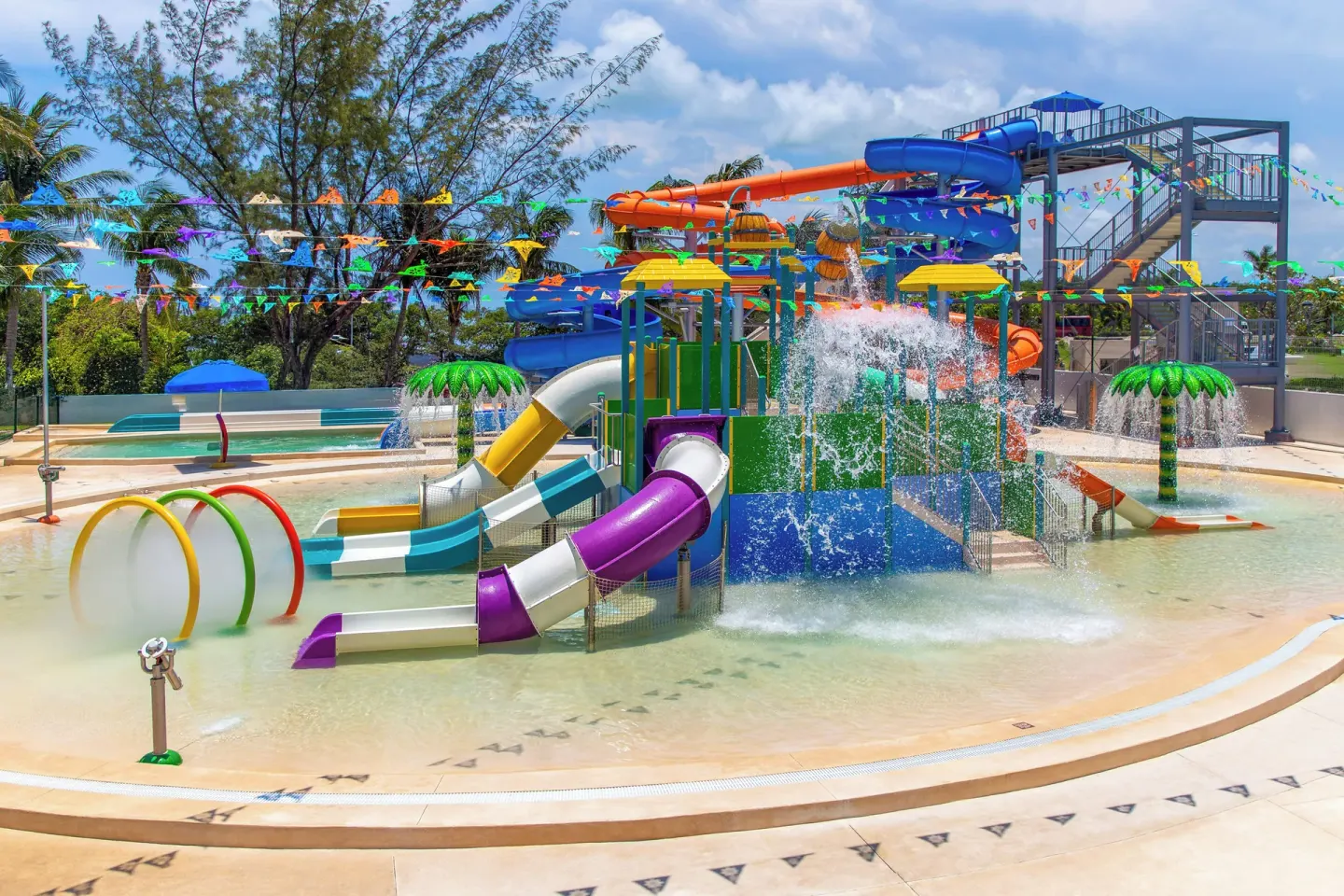Splash pool with colorful slides and spraying water features at Melia Casa Maya Cancun.