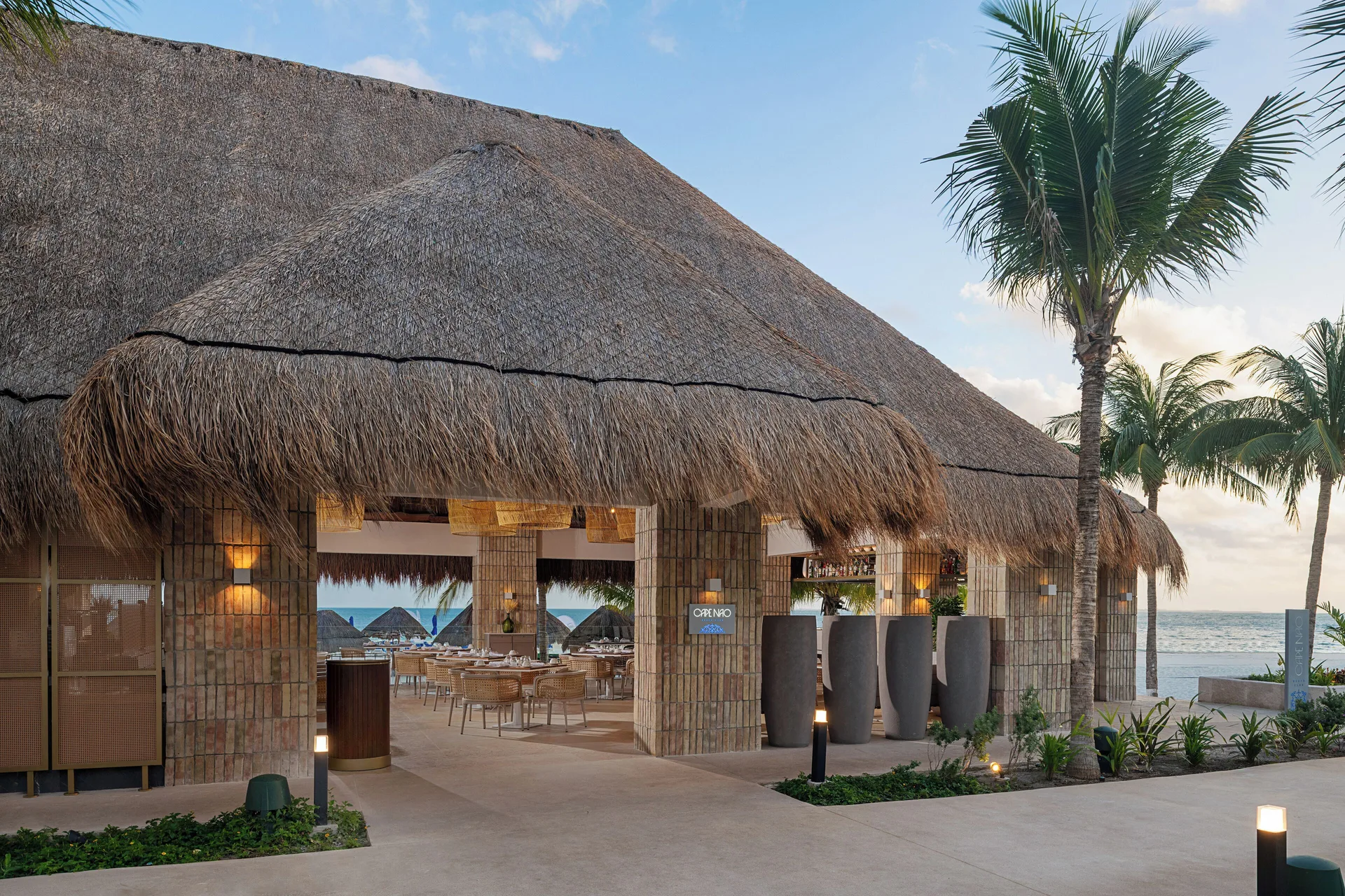Cape Nao beachfront restaurant with thatched roof at Melia Casa Maya Cancun.