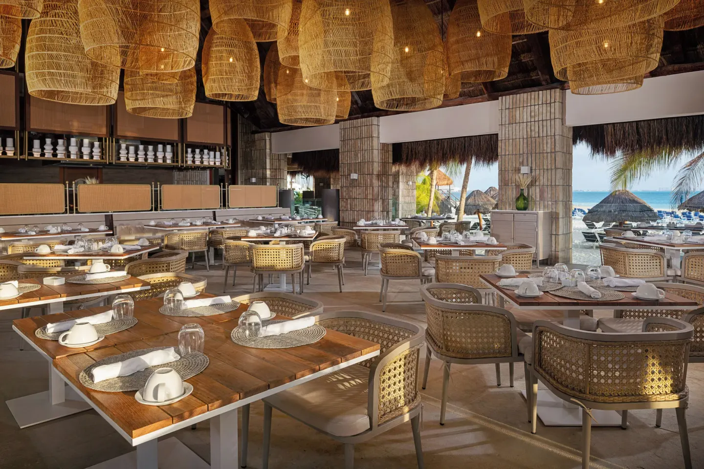 Cape Nao dining room with set tables and ocean views at Melia Casa Maya Cancun.