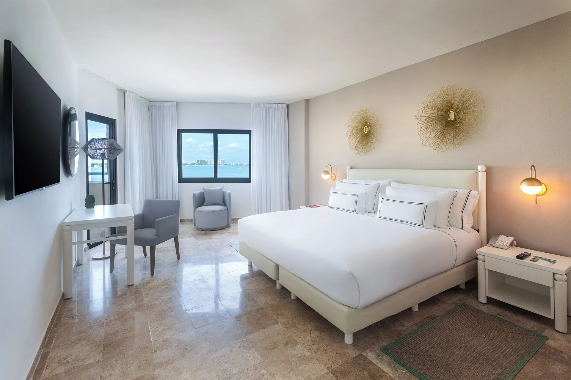 Melia Casa Maya Cancun bedroom with king bed and sea-facing window at Melia Casa Maya Cancun.