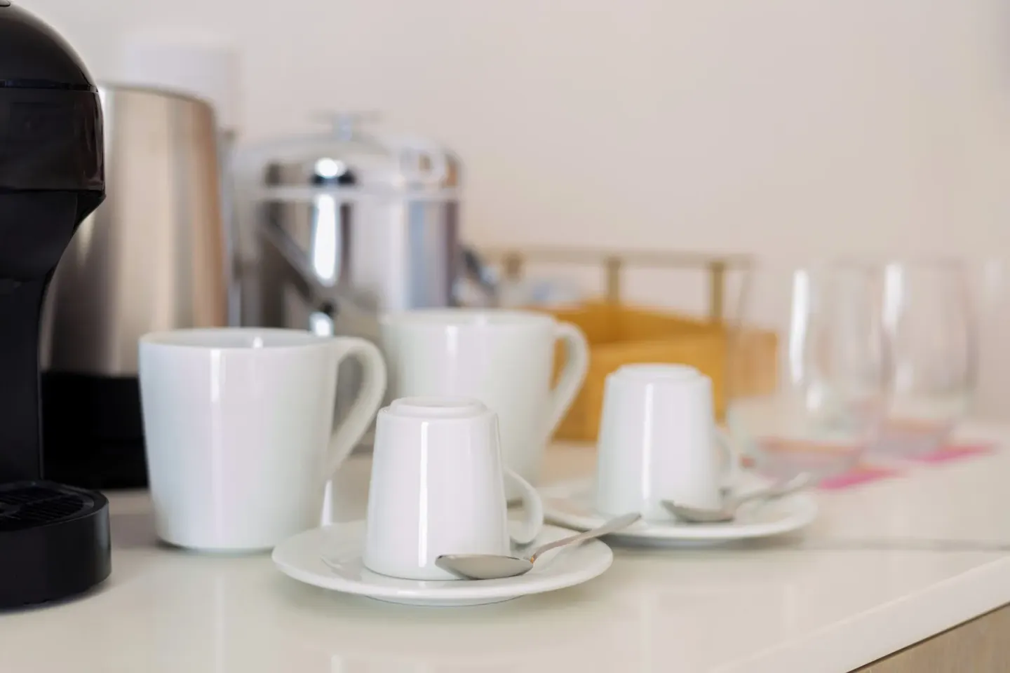 The Level Grand Suite coffee setup with cups, saucers, kettle, and glasses at Melia Casa Maya Cancun.