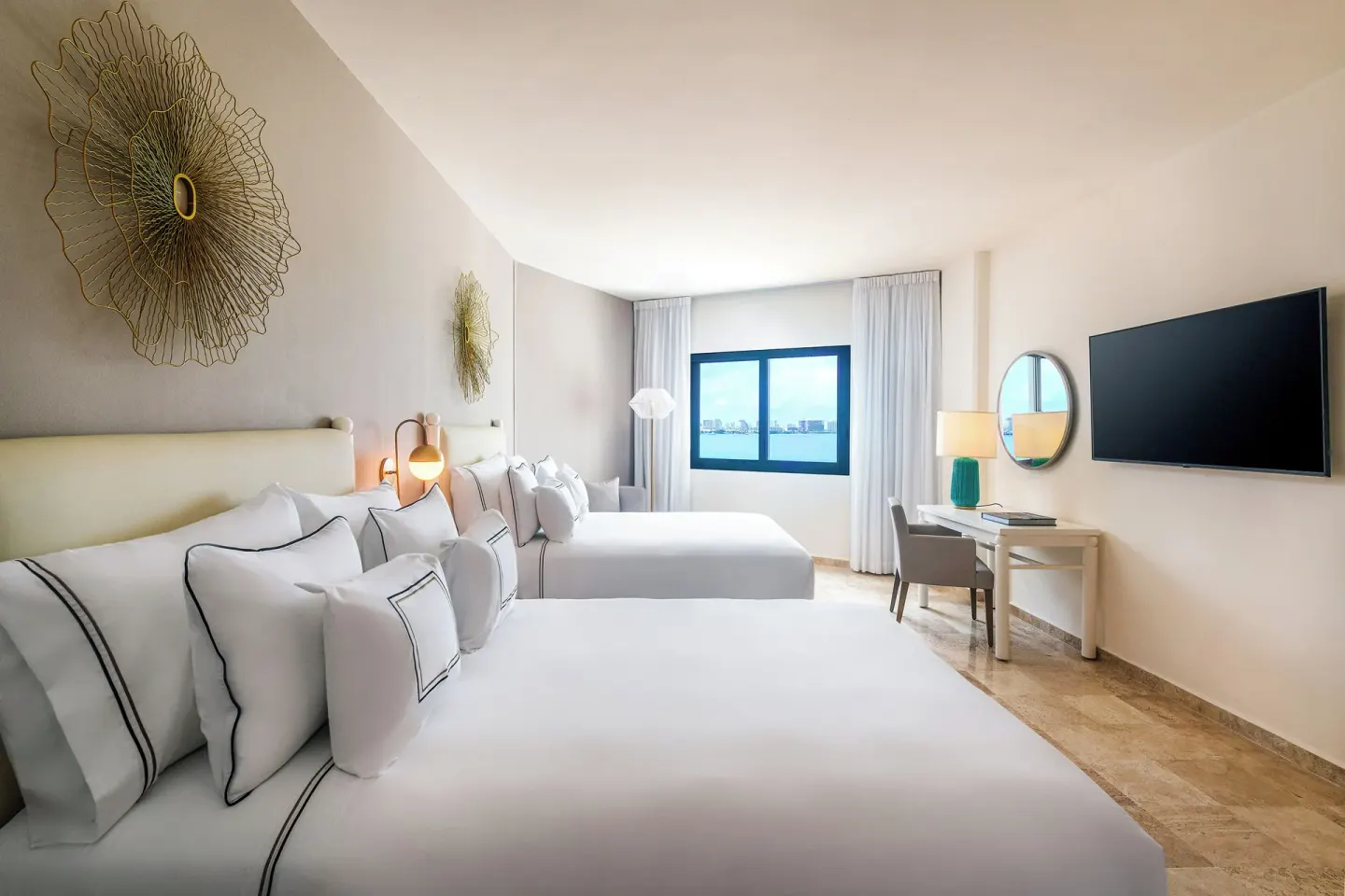 The Level Grand Suite bedroom with two beds and water-view window at Melia Casa Maya Cancun.