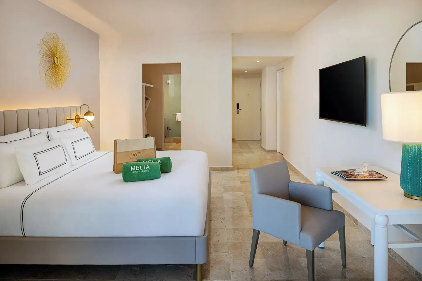 The Level Room Swim Up king bed and desk area at Melia Casa Maya Cancun with wall-mounted TV.