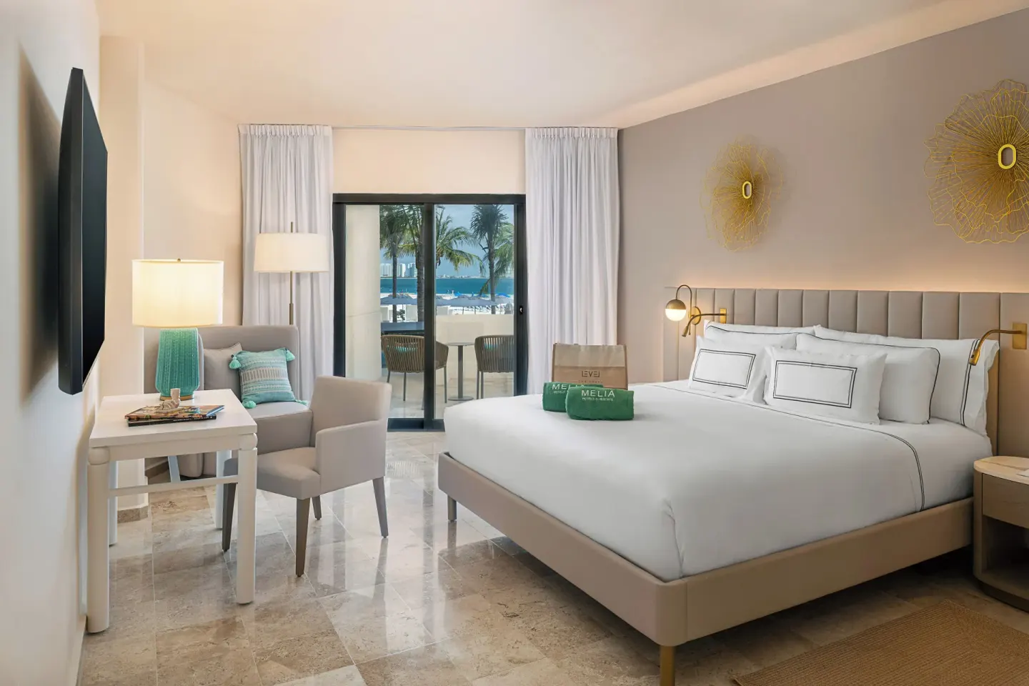 The Level Room Swim Up king bed at Melia Casa Maya Cancun with seating and sliding doors to the terrace.