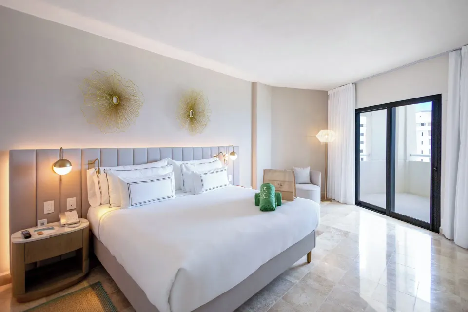 The Level Ocean View Suite king bedroom with balcony doors at Melia Casa Maya Cancun.