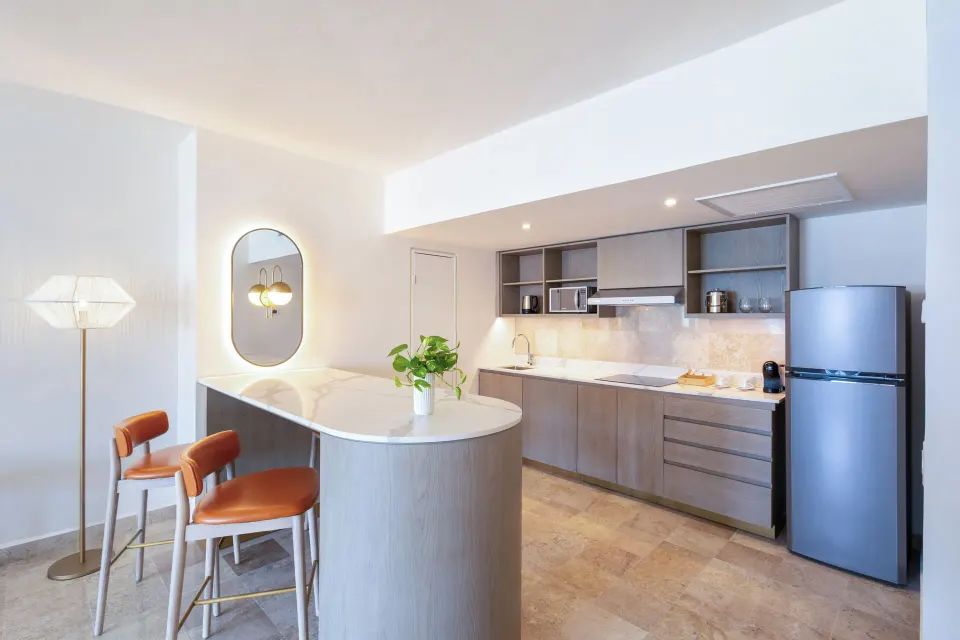 The Level Ocean View Suite kitchenette with island seating at Melia Casa Maya Cancun.