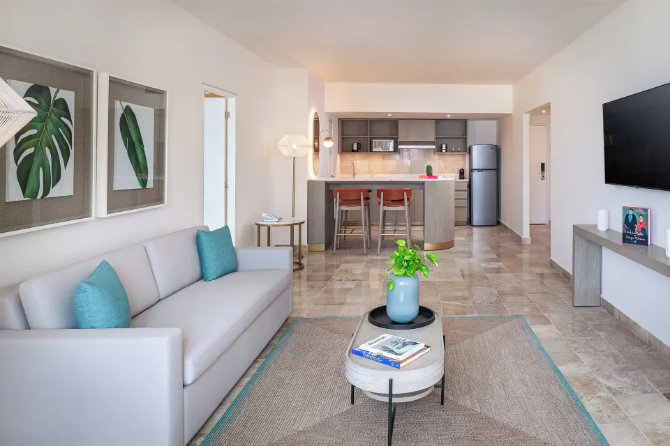 The Level Ocean View Suite living room with sofa and kitchenette at Melia Casa Maya Cancun.