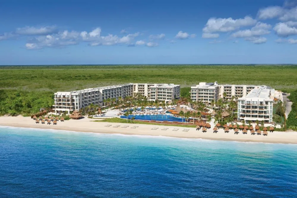 Dreams Riviera Cancun Resort & Spa family-friendly all-inclusive resort with beachfront pools and palapa-style architecture in Puerto Morelos, Mexico.