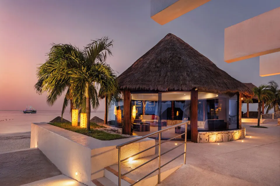 Night view of the illuminated beach palapa pavilion at Melia Cozumel.