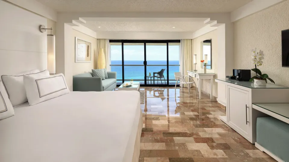 Spacious suite at Melia Cozumel with sliding wooden doors and a separate living and dining area.