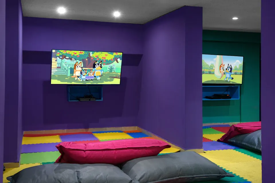 Colorful kids TV playroom with floor cushions at Melia Cozumel