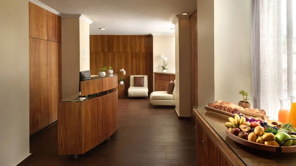 Resort reception area with wooden desk and fruit display at Melia Cozumel