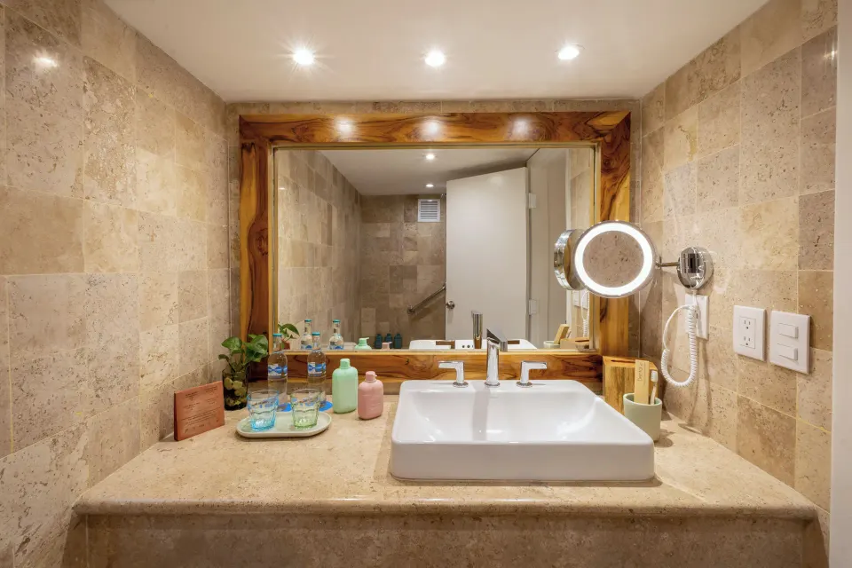 Bathroom sink and mirror with toiletries in a Premium Room at Melia Cozumel