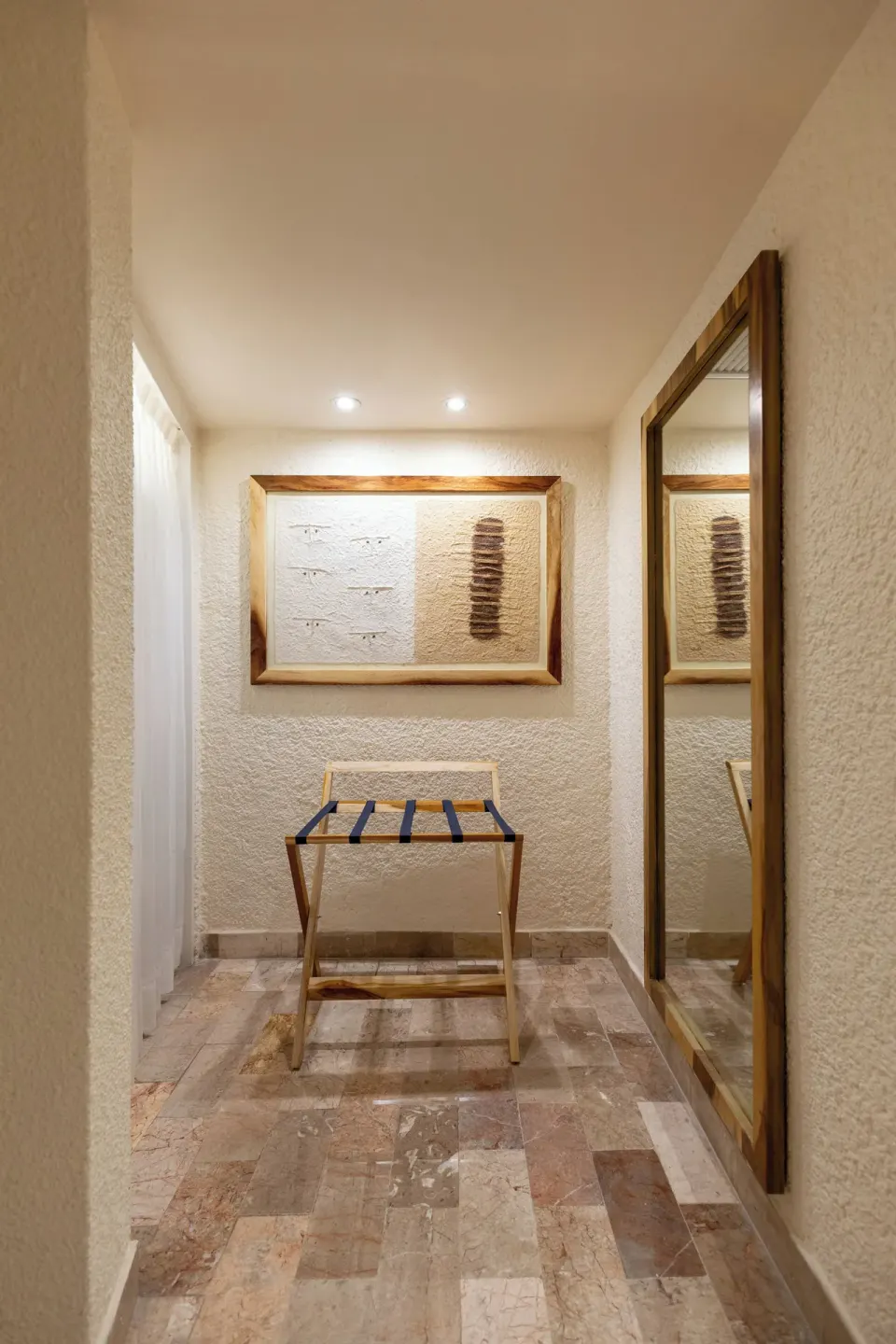 Entryway with luggage rack and full-length mirror in a Premium Room at Melia Cozumel