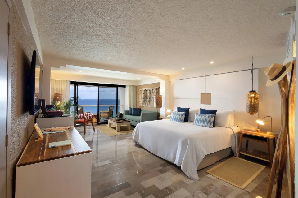 Spacious Premium Room with king bed seating area and ocean view at Melia Cozumel