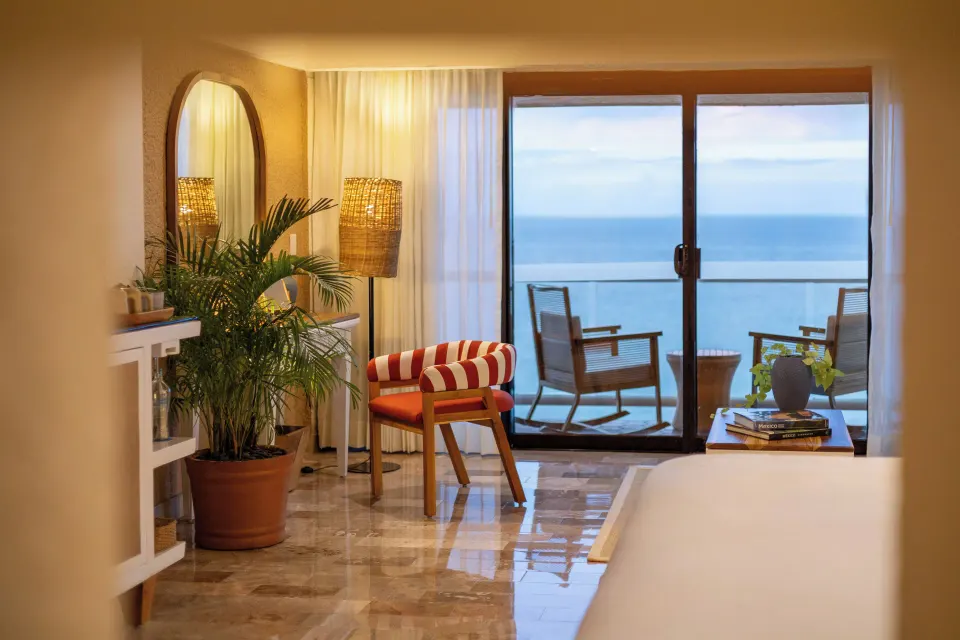 Balcony and ocean view from ZEL Premier Suite Ocean Front with chair and small table at Melia Cozumel