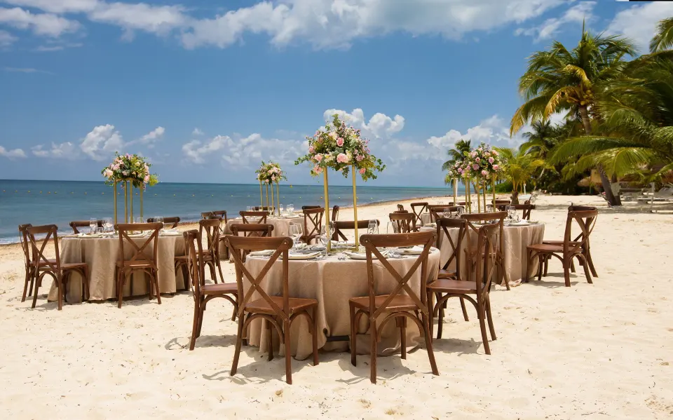 Daytime beach reception tables and chairs set on Melia Cozumel sand