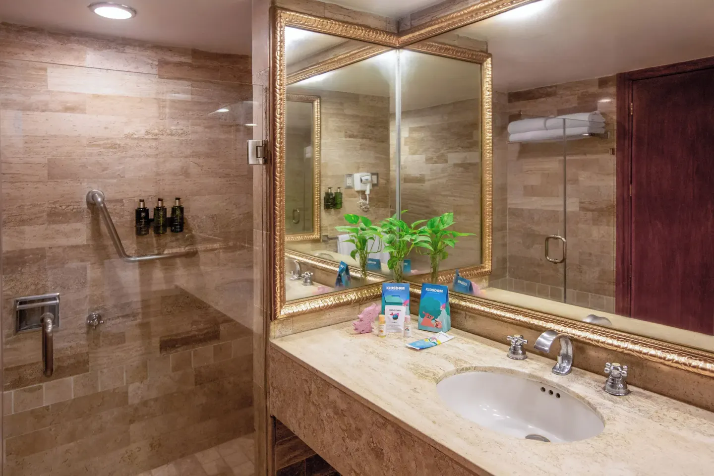 Bathroom sink and glass shower with child bath items at Melia Puerto Vallarta.