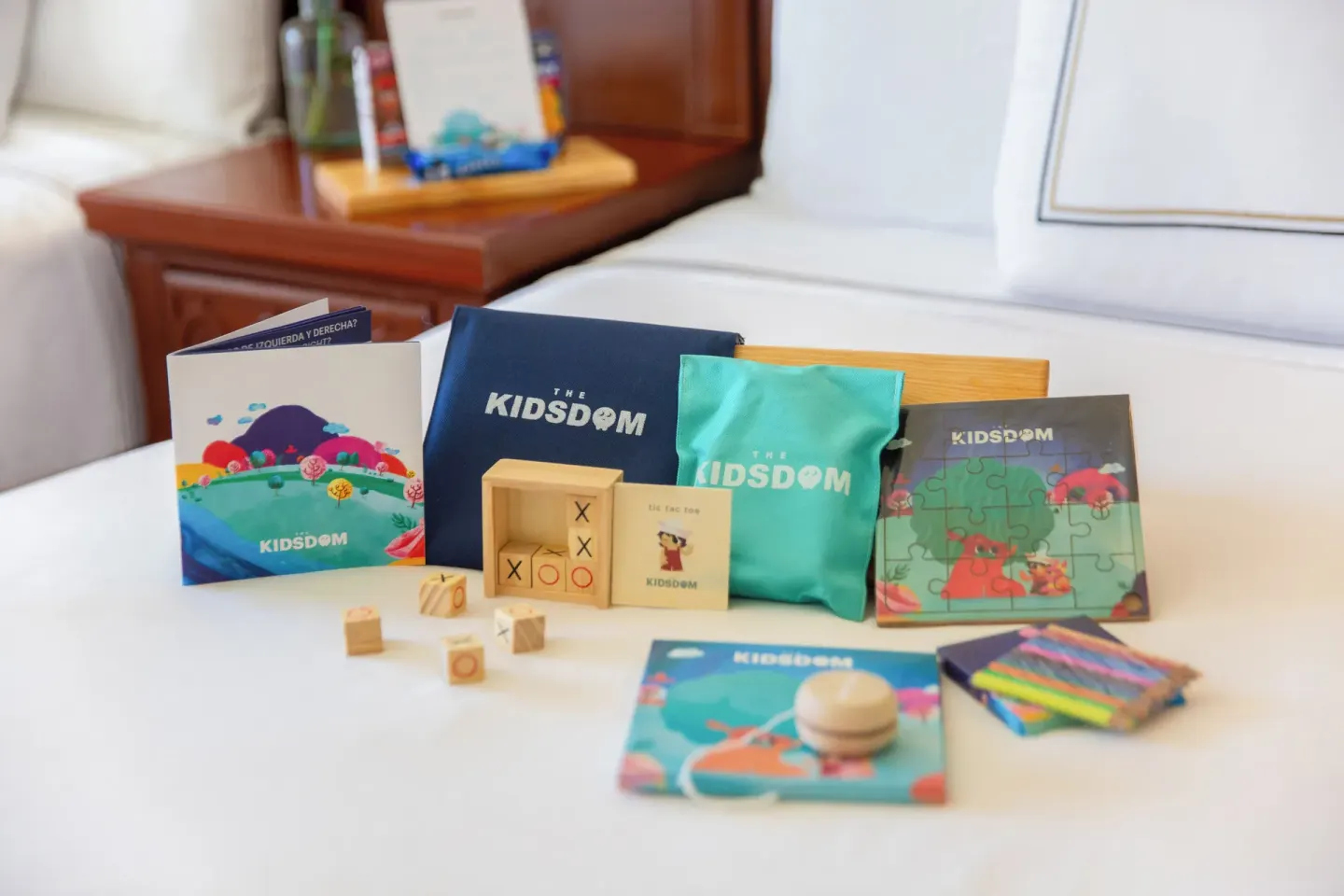 Children’s activity kit with games, puzzle, and art supplies on a bed at Melia Puerto Vallarta.