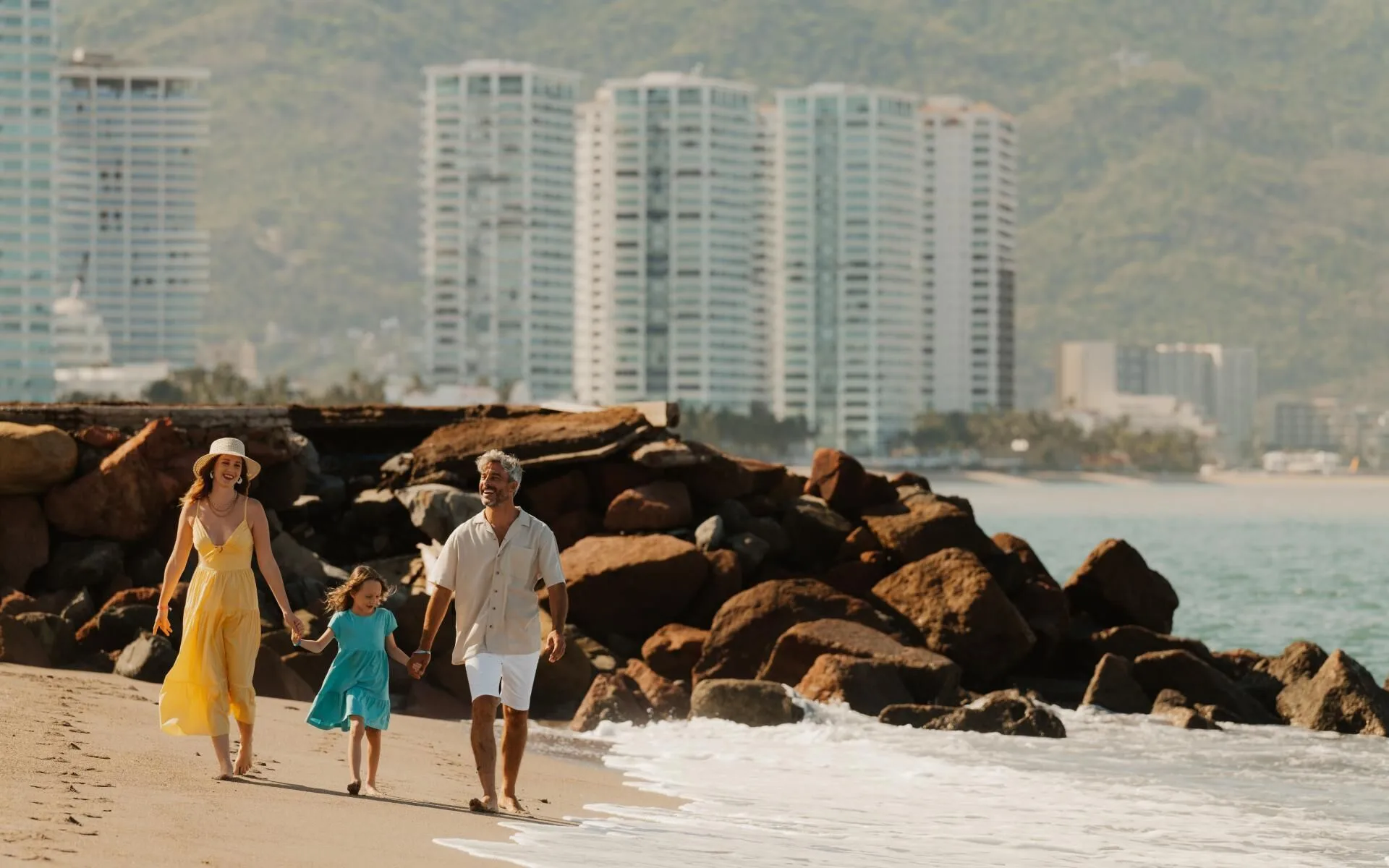 Family walking along the shoreline near Melia Puerto Vallarta.