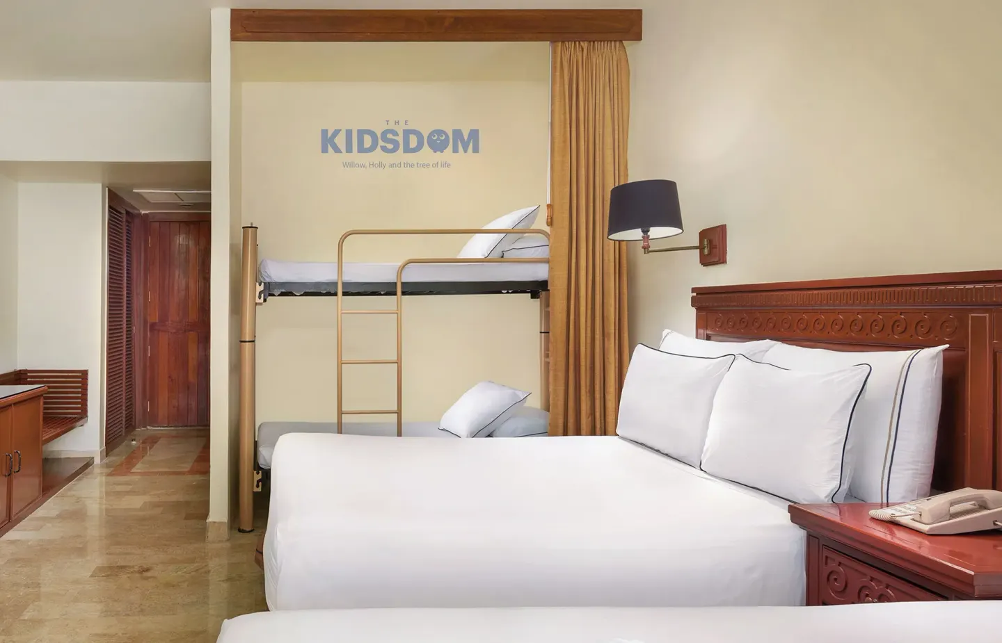 Family guest room with king bed and bunk bed alcove at Melia Puerto Vallarta.