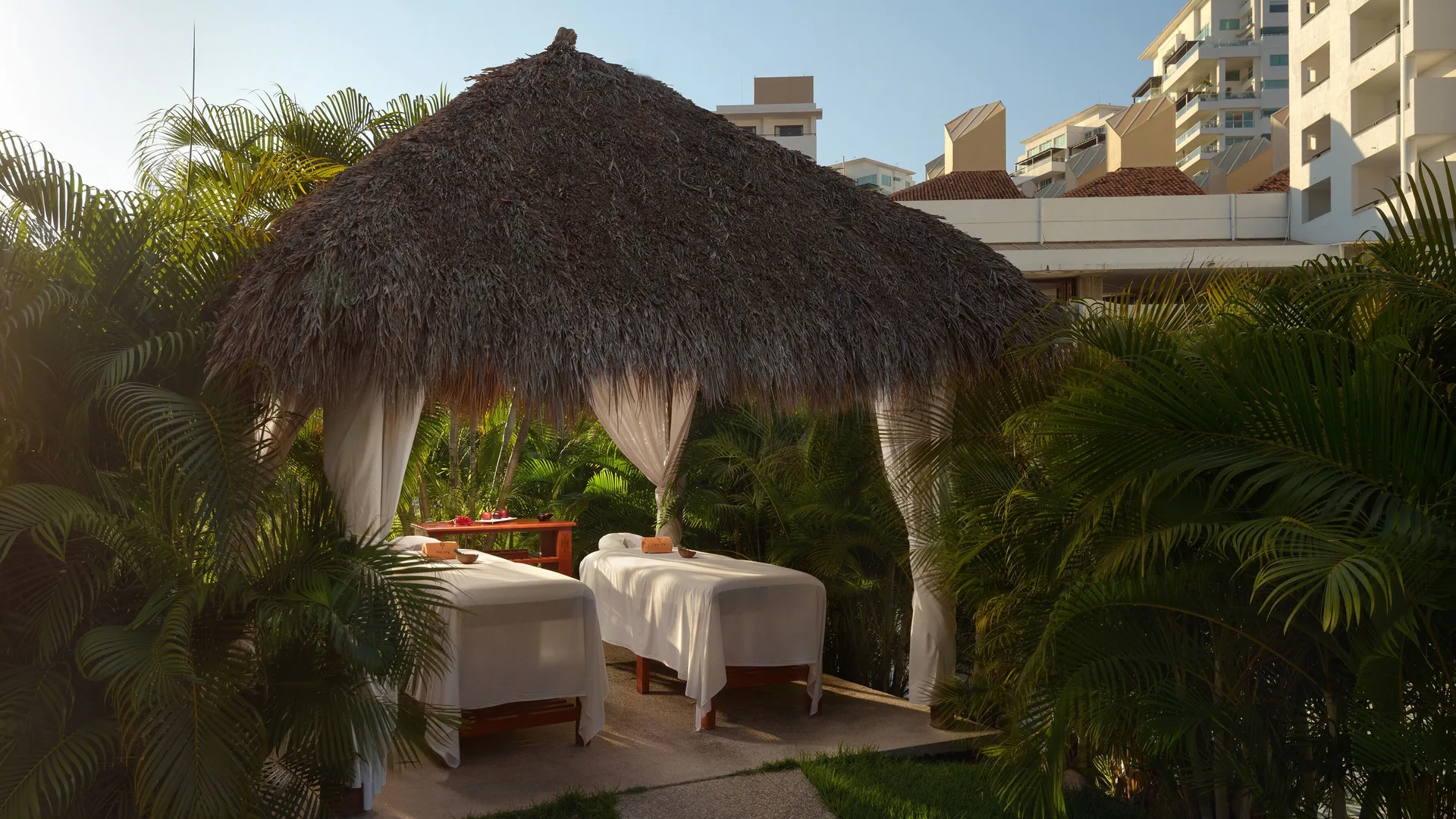 Thatched garden spa cabana with two massage tables at Melia Puerto Vallarta.