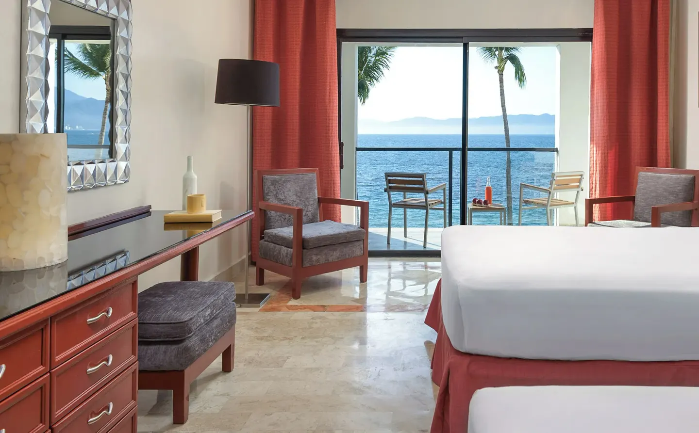 Ocean-view guest room with two beds and balcony seating at Melia Puerto Vallarta.
