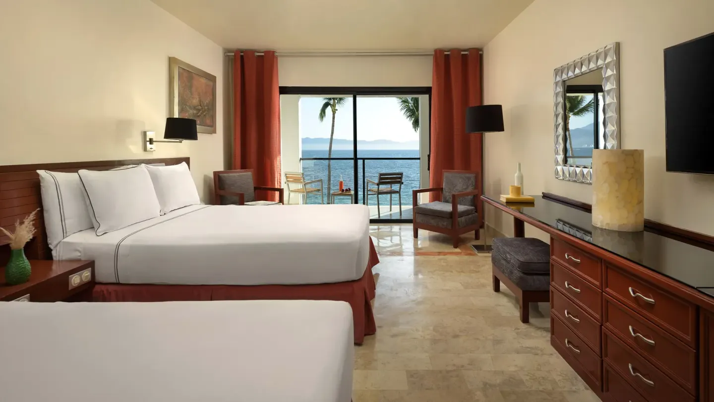 Two-bed ocean-view guest room with balcony at Melia Puerto Vallarta.