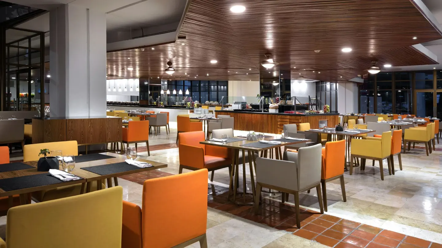 Restaurant dining room with buffet counters and colorful chairs at Melia Puerto Vallarta.