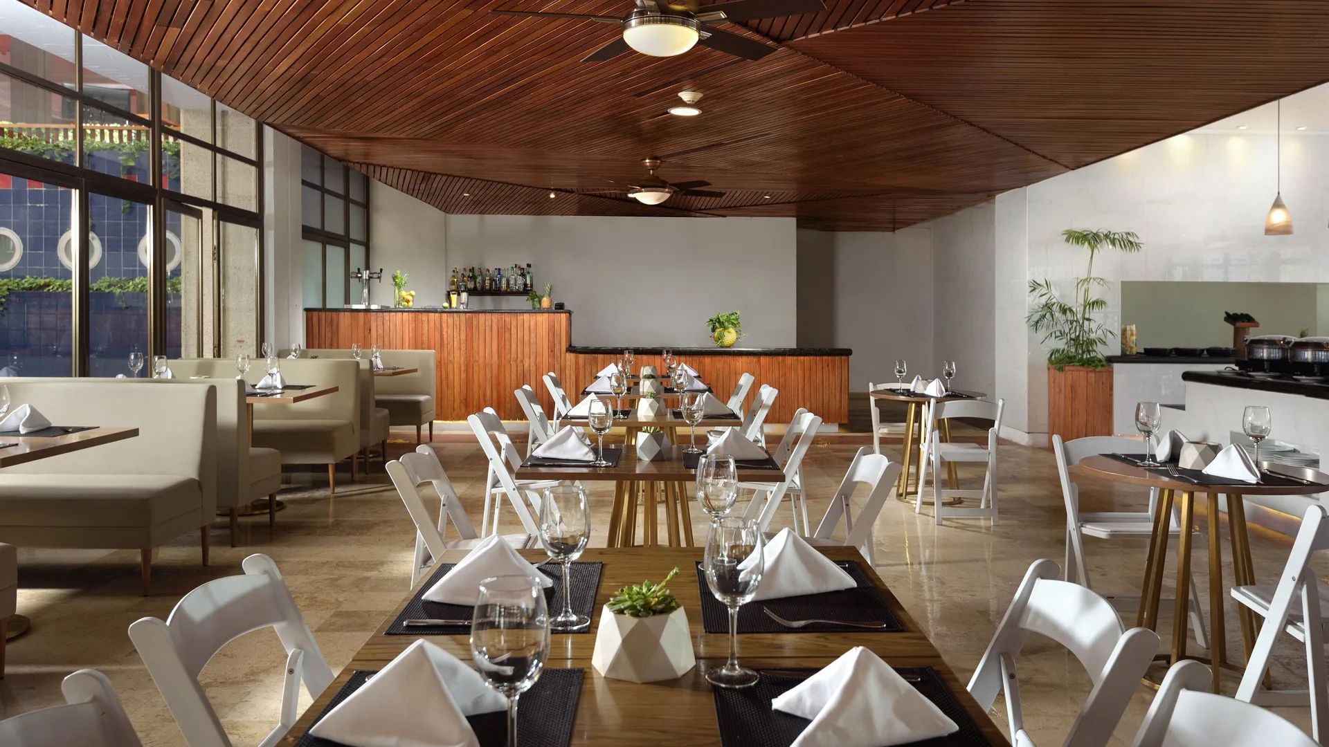 Restaurant dining room with wine glasses and wood ceiling at Melia Puerto Vallarta.